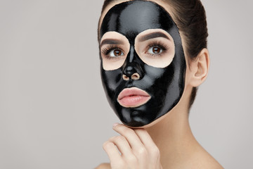Beauty Face Care Peeling. Closeup Female With Black Peeling Mask On Skin