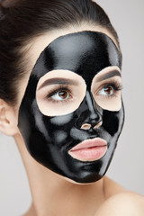 Cosmetology Mask. Beautiful Female With Black Peel Mask On Face