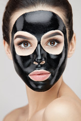 Cosmetology Mask. Beautiful Female With Black Peel Mask On Face