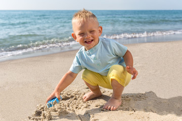 Summer ,day,beach, boy playing in sand
