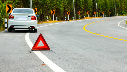 Red emergency stop sign on the road.