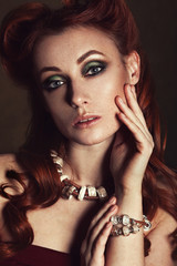 Obraz premium Beauty portrait of a beautiful redhead girl with bright make-up