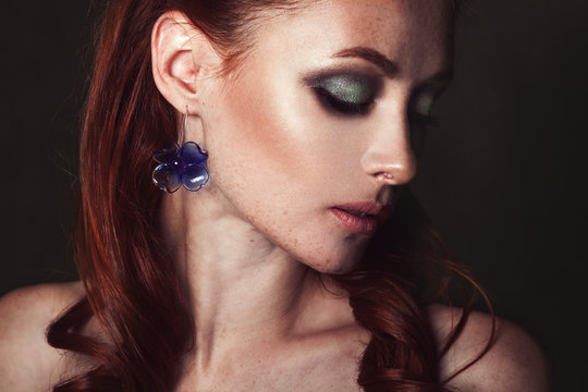 Beauty portrait of a beautiful redhead girl with bright make-up