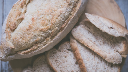 fresh bread and baked goods on wooden chopping board, rustic style
