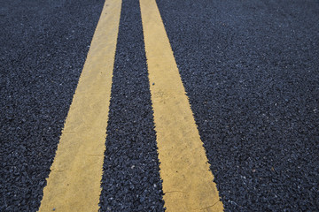 Obraz premium Closeup asphalt road with marking lines for giving directions, traffic lines concept