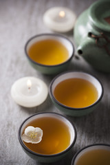 Green tea with Jasmine flower and candles in ceramic Chinese.