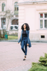 Obraz premium Young african american girl in jeans posing 
