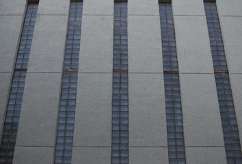 A gray industrial building with narrow windows. Soviet Modernism