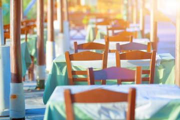 Tables and chairs in a street restaurant in Kamari on Santorini