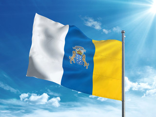 Canary Islands flag waving in the blue sky