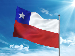 Fototapeta na wymiar Chile flag waving in the blue sky