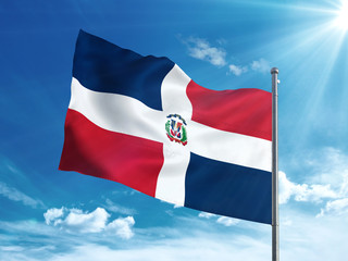 Dominican Republic flag waving in the blue sky