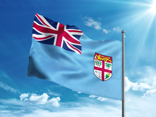 Republic of Fiji flag waving in the blue sky