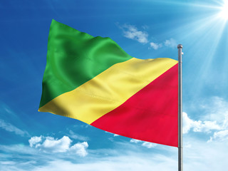 Republic of the Congo flag waving in the blue sky