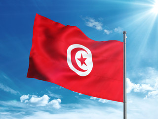 Tunisia flag waving in the blue sky