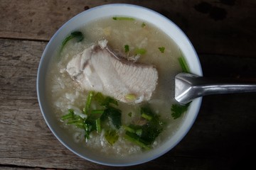 Rice soup in blue plastic bowl and the spoon