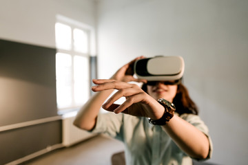 Handsome young woman wearing virtual headset.