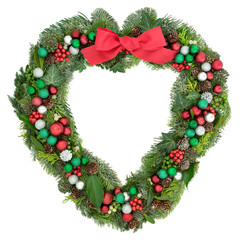 Fototapeta na wymiar Christmas heart wreath decoration with red bow, baubles, holly, mistletoe and winter greenery on white background.