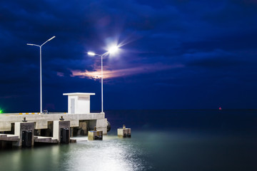 The pier that extends into the sea. Combined with a beautiful atmosphere at night.