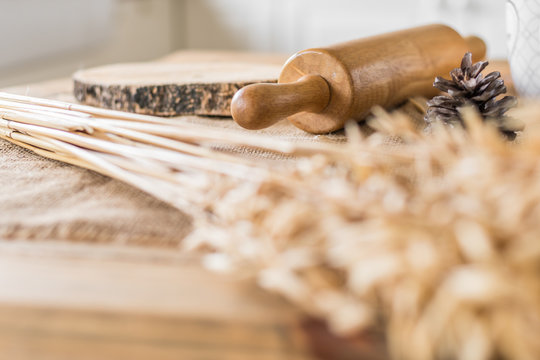 Rolling pin on wooden table in kitchen selective focus