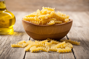 Fusilli pasta in wooden bowl