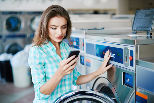 Woman washing clothes via app