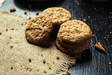 Biscuit sweet cookie background. Domestic stacked butter biscuit pattern concept,close up macro.Homemade cookies on wooden table.Cereal biscuits with the sesame,peanuts,sunflower and amaranth.