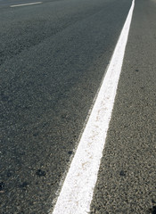 Obraz premium White road marking on asphalt, 