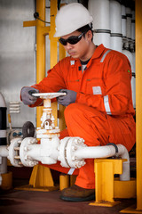Technician, technician during open or close manual ball valve for control process in oil and gas flatform offshore