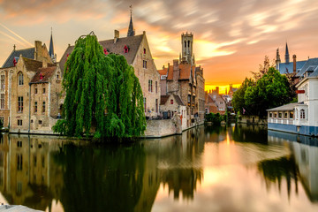 Bruges (Brugge) cityscape with water canal at sunset