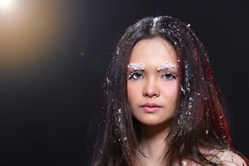 Woman with Gllitter Snowflake in dark background