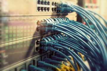 Network cables in switch and firewall in cloud computing data center server rack