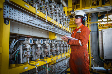Technician,Instrument technician on the job recoad morning data or function check pressure transmitters in process oil and gas platform offshore,technician