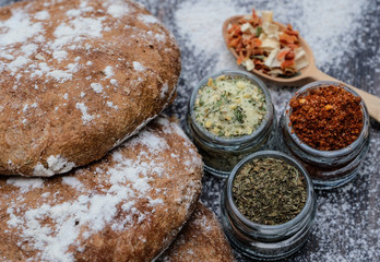 Fresh  bread and different spicies in jars