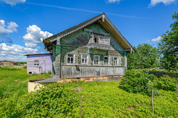 Abandoned old house in a Russian village with ornaments on the facade.