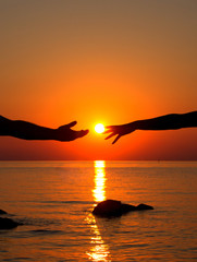 Hands in love in the setting sun