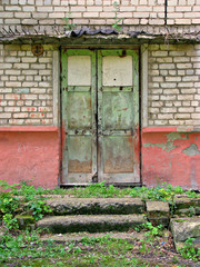 Old abandoned door in a brick building.