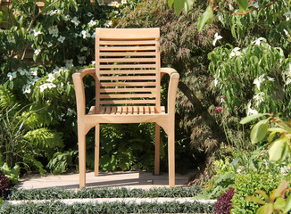 Obraz premium A Wooden Chair for Relaxing in the Garden.