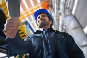 Men shaking hands in an industrial facility