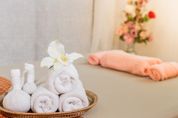 Massage item and Spa Oil in Basket on Bed