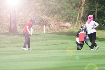 Woman golf is a sport requiring heat tolerance.
