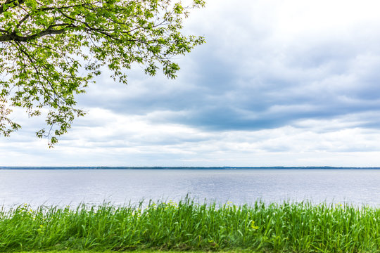Calm and peaceful St Lawrence river water in Quebec, Canada with stormy clouds during summer