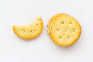 Dry cream cracker, which was bitten on a white background.