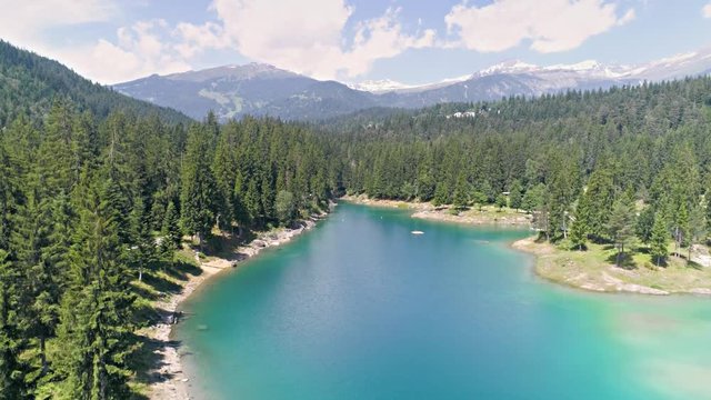 Aerial footage in 4k quality of a beautiful lake in the Swiss mountains called Caumasee.