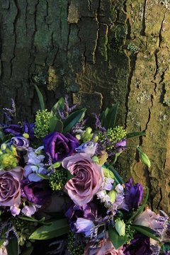 Purple Sympathy flowers near a tree