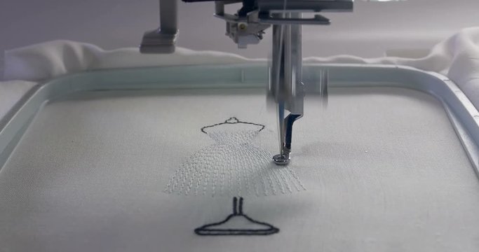 Machine embroidery work.Working embroidery machine. Textile - Professional and industrial embroidery machine. Needle moves quickly, embroidering a pattern