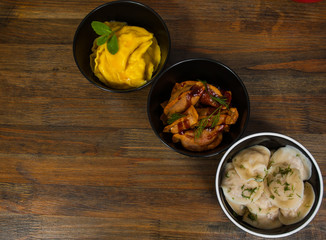 Set of different dumplings and ravioli on a wooden table. top view. with copy space.