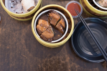 Steamed dumplings Dim Sum in bamboo steamer in selective focus.