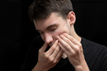 Fototapeta premium The young boy is suffering of painful toothache