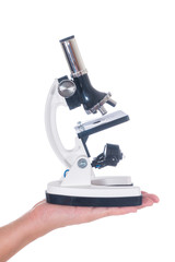 Female hand holding white science microscope isolated on white background
